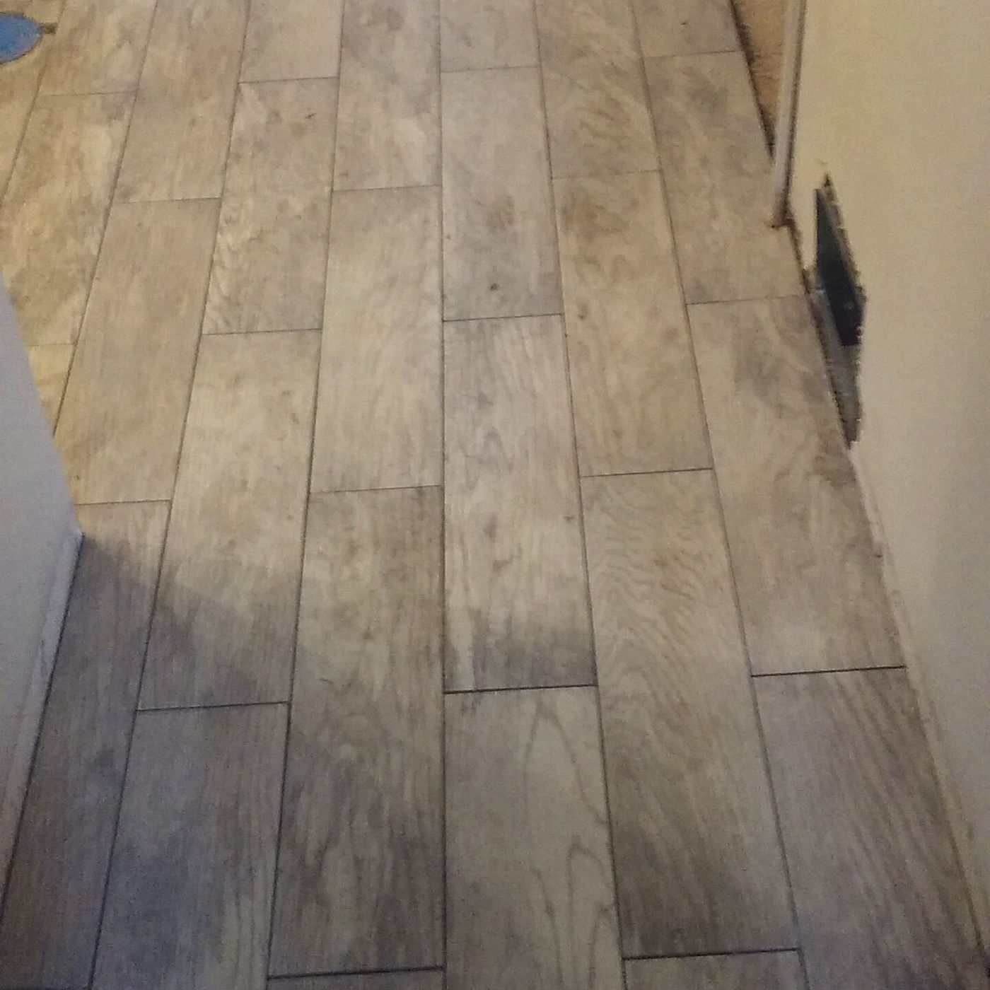 Newly set wood-look plank tile flooring